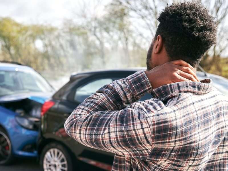 man experiencing whiplash pain following car accident